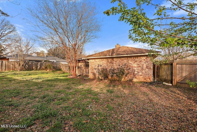 view of yard with a fenced backyard