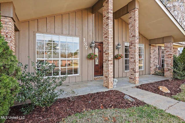 property entrance with brick siding and board and batten siding