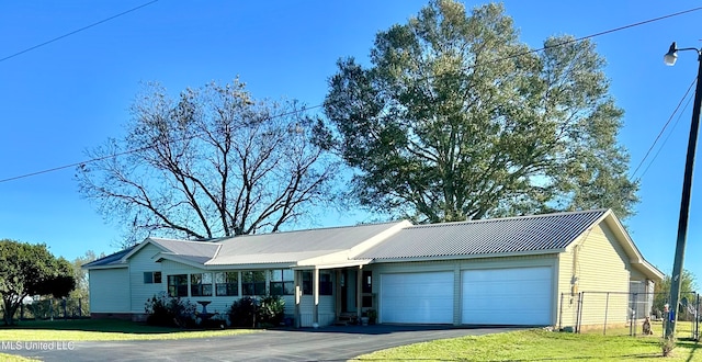 single story home with a garage and a front yard