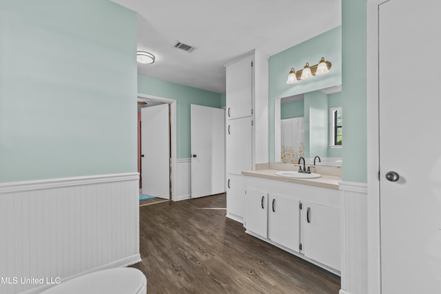 bathroom featuring hardwood / wood-style flooring, vanity, and toilet