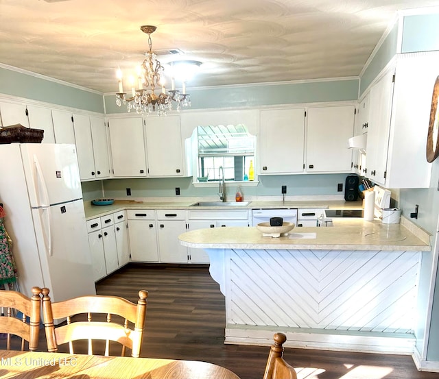 kitchen featuring white cabinetry, sink, dark hardwood / wood-style floors, decorative light fixtures, and white appliances