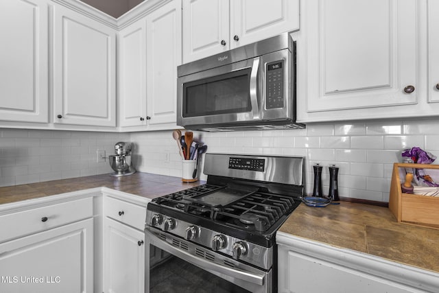 169 Beechwood Cir, Pearl, MS 39208 - kitchen featuring appliances with stainless steel finishes, white cabinetry, and decorative backsplash