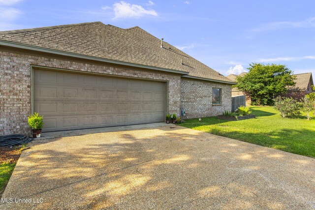 169 Beechwood Cir, Pearl, MS 39208 - view of home's exterior with brick siding, driveway, a shingled roof, and an attached garage