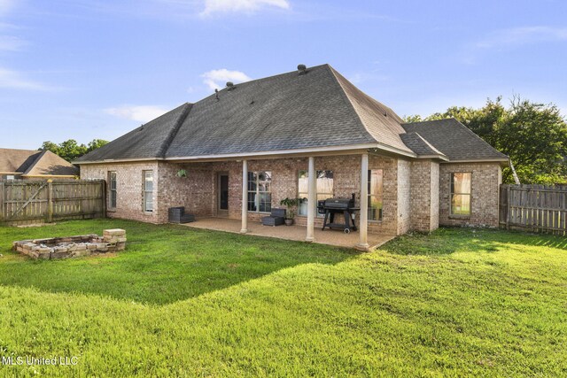 169 Beechwood Cir, Pearl, MS 39208 - rear view of property featuring brick siding, roof with shingles, a patio, and a fire pit