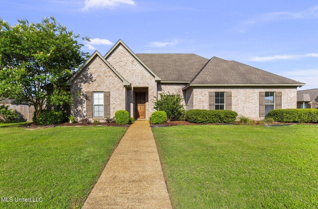 169 Beechwood Cir, Pearl, MS 39208 - french country home featuring brick siding and a shingled roof