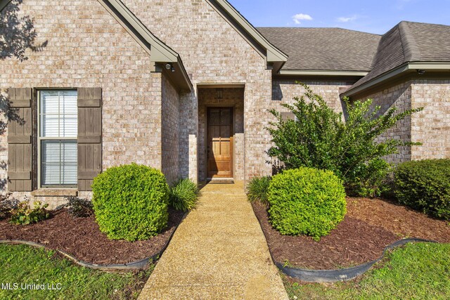 169 Beechwood Cir, Pearl, MS 39208 - view of exterior entry featuring brick siding and roof with shingles