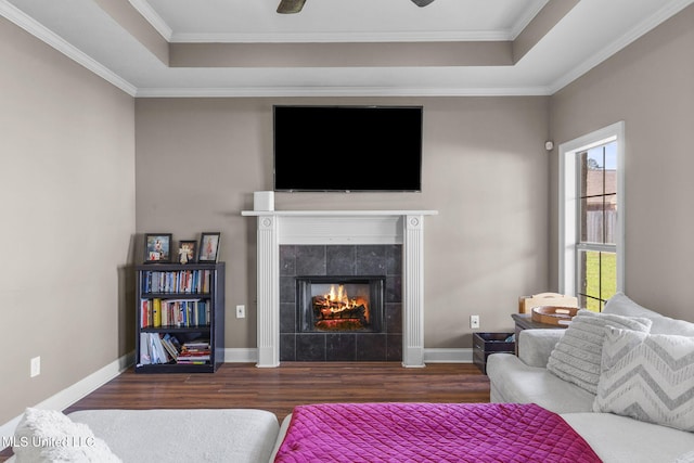 169 Beechwood Cir, Pearl, MS 39208 - living room featuring a tray ceiling, wood finished floors, a tiled fireplace, and ornamental molding