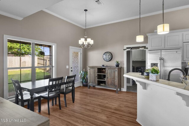 169 Beechwood Cir, Pearl, MS 39208 - dining room featuring crown molding, dark wood-style floors, a chandelier, baseboards, and a barn door