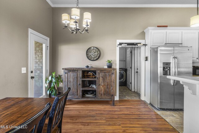 169 Beechwood Cir, Pearl, MS 39208 - dining space featuring a chandelier, ornamental molding, wood finished floors, and washer / clothes dryer