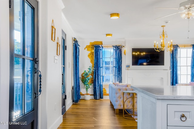 corridor with a chandelier, ornamental molding, and hardwood / wood-style flooring