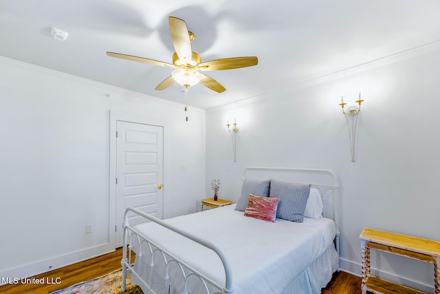 bedroom with ceiling fan, dark hardwood / wood-style flooring, and ornamental molding