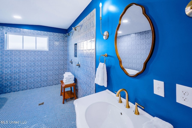 bathroom with sink and lofted ceiling