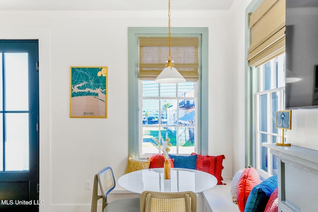 dining area with plenty of natural light and crown molding