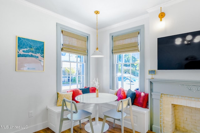 dining space featuring wood-type flooring and crown molding