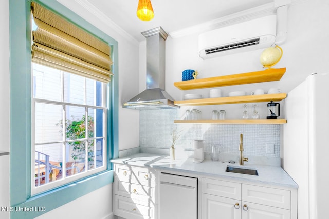 kitchen with white cabinets, an AC wall unit, wall chimney exhaust hood, ornamental molding, and tasteful backsplash