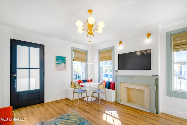 entrance foyer with hardwood / wood-style floors, ornamental molding, and an inviting chandelier