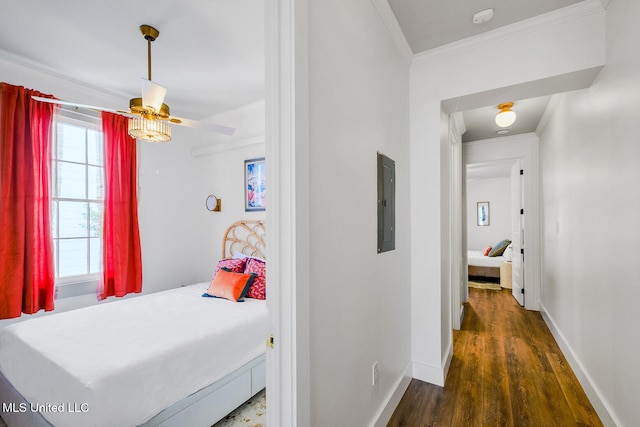 bedroom featuring dark hardwood / wood-style flooring, electric panel, ceiling fan, and ornamental molding