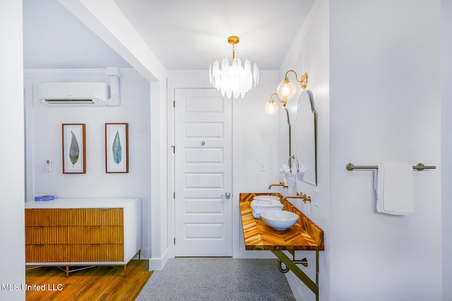 bathroom with hardwood / wood-style floors, an inviting chandelier, and an AC wall unit