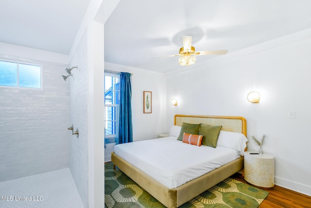 bedroom with hardwood / wood-style floors, ceiling fan, and multiple windows