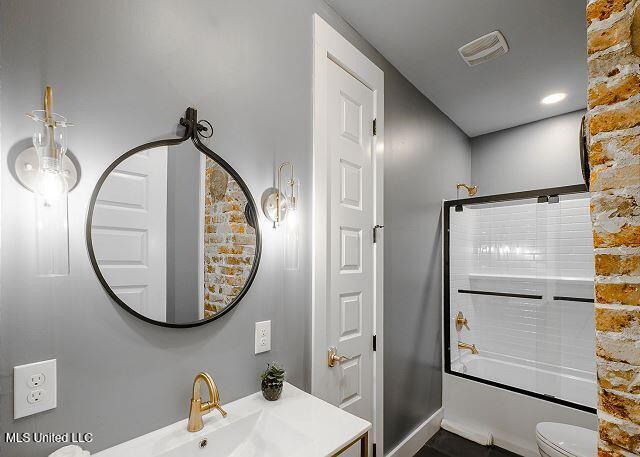 full bathroom with vanity, toilet, and shower / bath combination with glass door