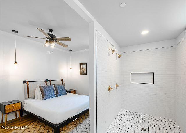 bedroom featuring ceiling fan and dark wood-type flooring