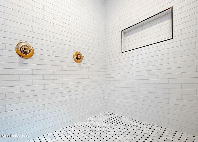 bathroom with tiled shower