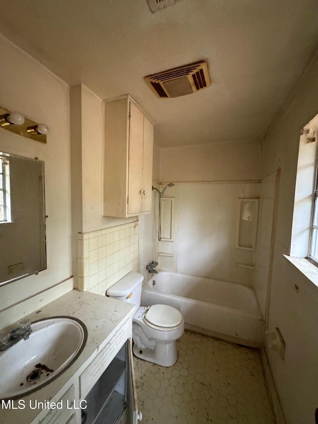 full bathroom with vanity, toilet, washtub / shower combination, and backsplash