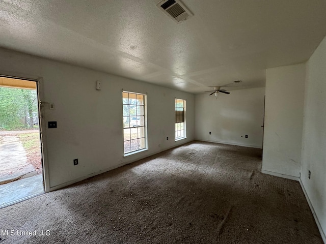 carpeted empty room with a textured ceiling and ceiling fan