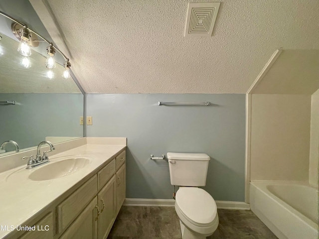 bathroom with vanity, lofted ceiling, and toilet