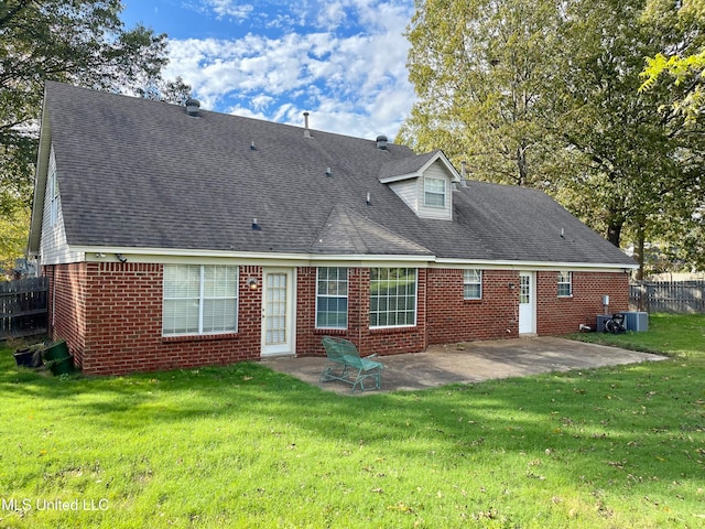 back of house featuring a patio and a lawn