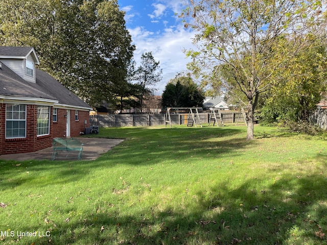 view of yard with a playground and a patio area