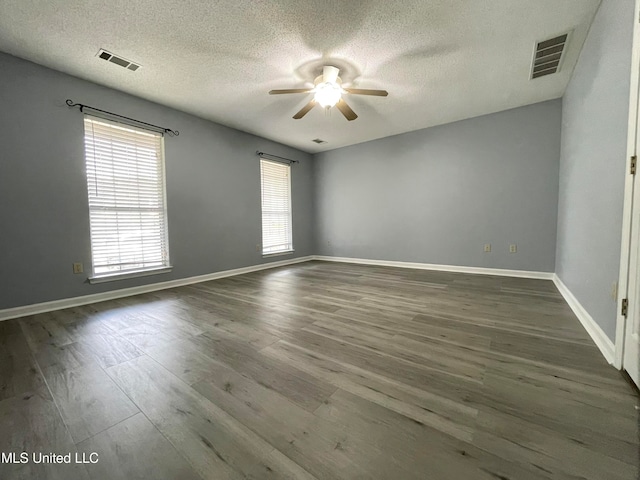 unfurnished room with a textured ceiling, dark hardwood / wood-style flooring, and ceiling fan