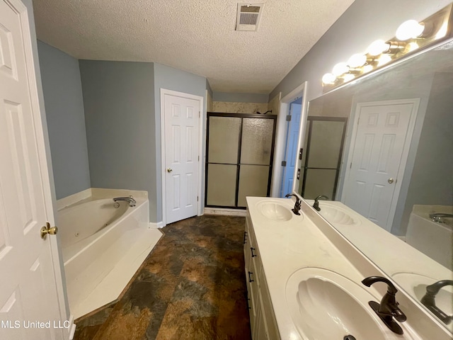 bathroom with vanity, a textured ceiling, and plus walk in shower