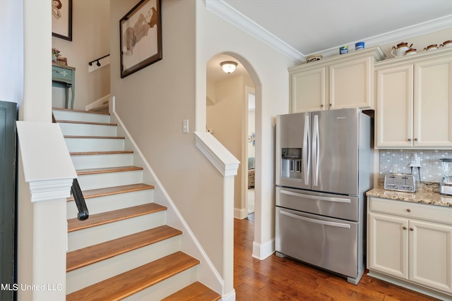 staircase with crown molding and hardwood / wood-style floors