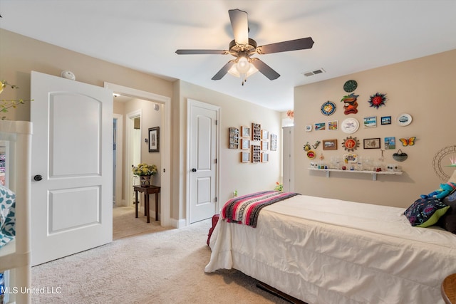 bedroom featuring light carpet and ceiling fan