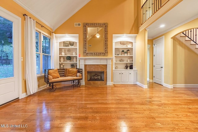 4655 Bonne Terre Dr, Nesbit, MS 38651 - living room with high vaulted ceiling, a premium fireplace, crown molding, wood finished floors, and stairway