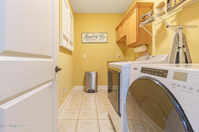4655 Bonne Terre Dr, Nesbit, MS 38651 - washroom with separate washer and dryer, cabinet space, light tile patterned floors, and baseboards