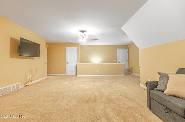 living room featuring light carpet and ceiling fan