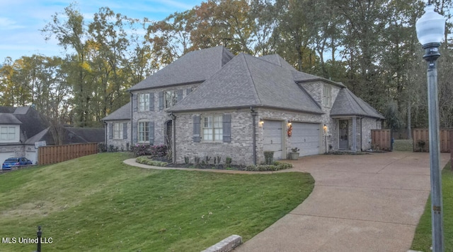 view of front of property featuring a garage and a front lawn