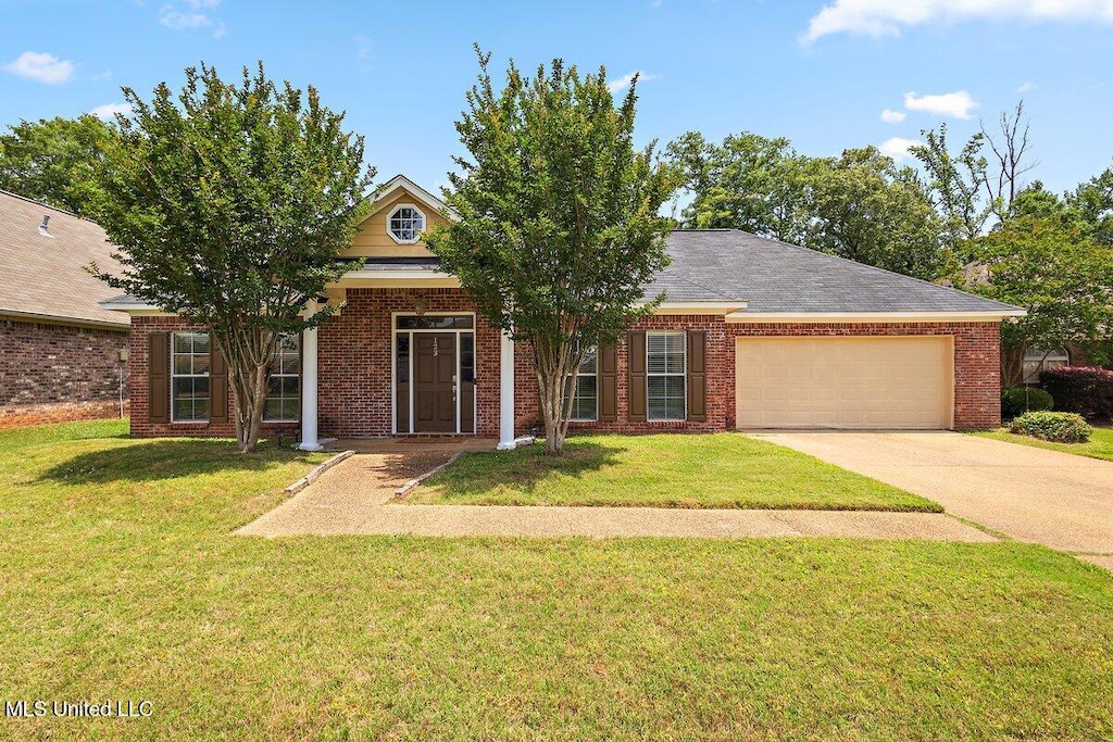 123 Sara Fox Dr, Brandon, MS 39047 - view of front of home with a garage, concrete driveway, a front lawn, and brick siding