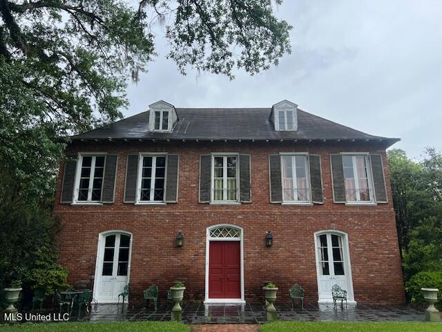 rear view of house featuring brick siding