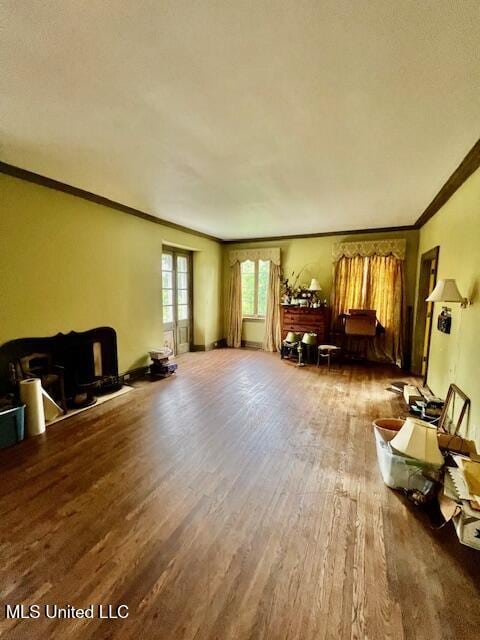 living area featuring wood finished floors and ornamental molding