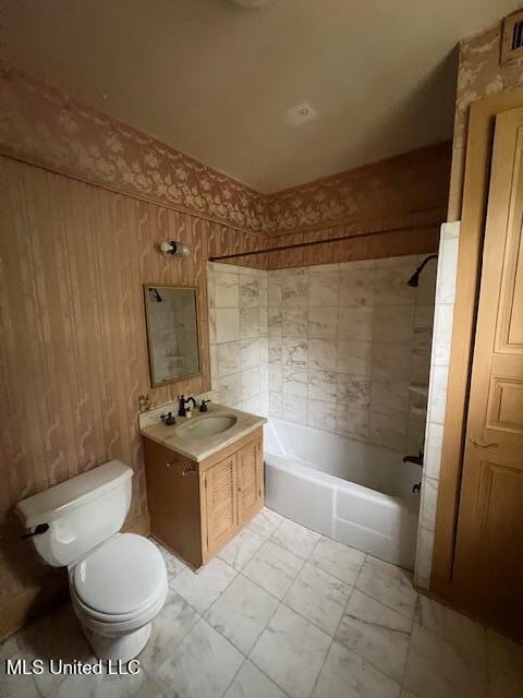full bath with marble finish floor, toilet, vanity, and shower / bathing tub combination