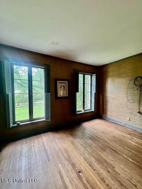 unfurnished room featuring wood finished floors and baseboards