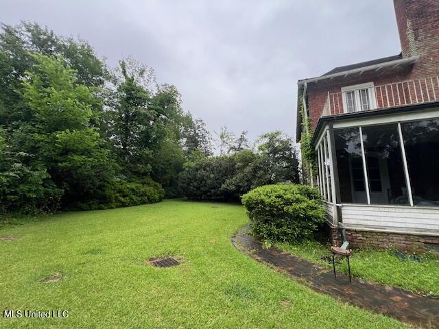 view of yard with a sunroom