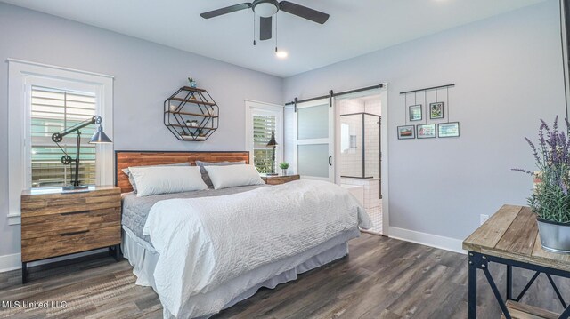 bedroom with ceiling fan, dark hardwood / wood-style floors, and a barn door