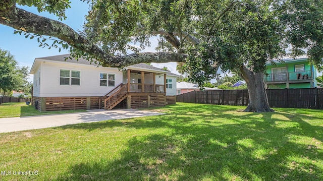 rear view of property with a lawn