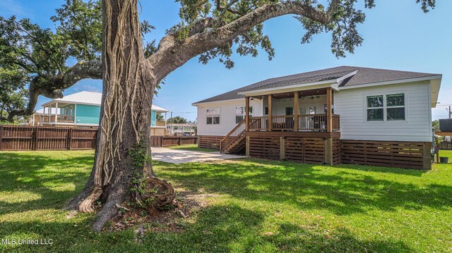 back of property featuring cooling unit and a lawn