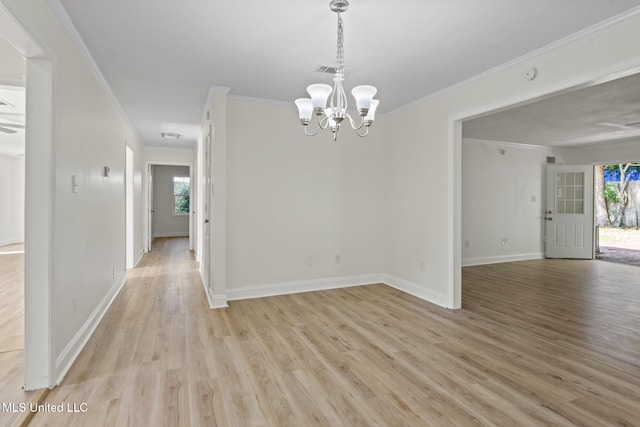 122 Carroll Ave, Long Beach, MS 39560 - spare room featuring crown molding, healthy amount of natural light, light wood-style floors, a chandelier, and a smoke detector