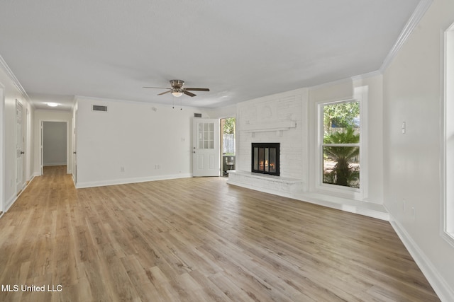 122 Carroll Ave, Long Beach, MS 39560 - unfurnished living room with a ceiling fan, light wood-style floors, a brick fireplace, and crown molding